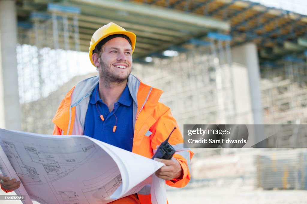 Worker reading blueprints on site