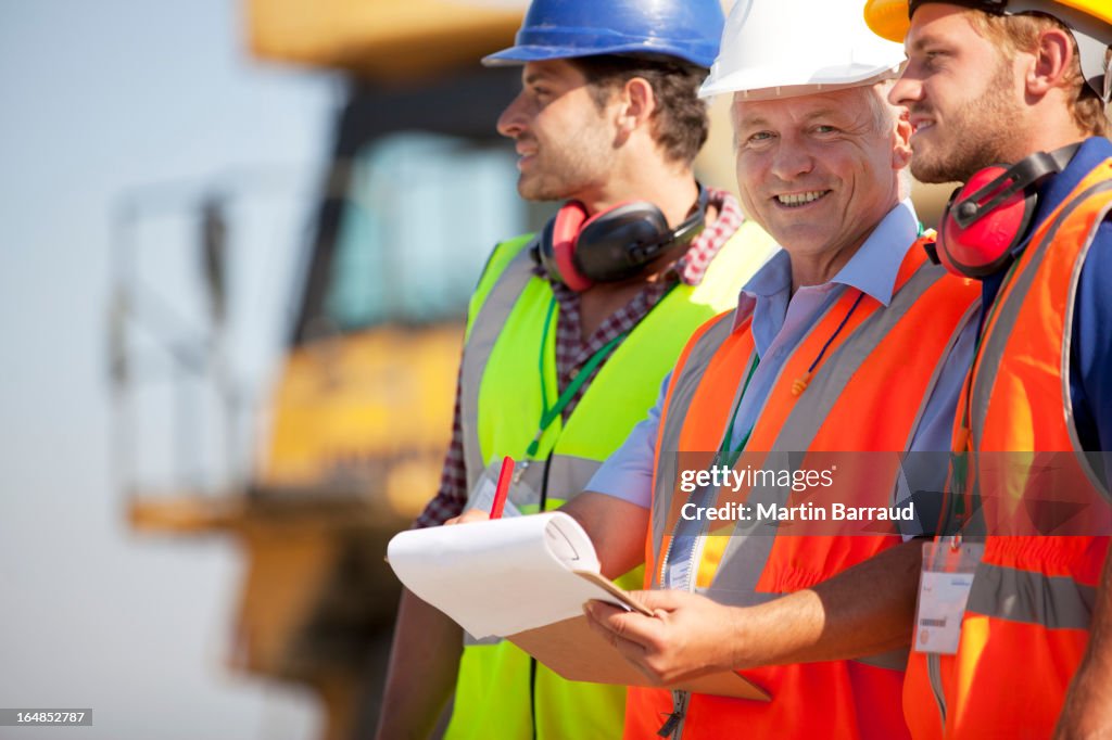 Businessman and workers talking on site