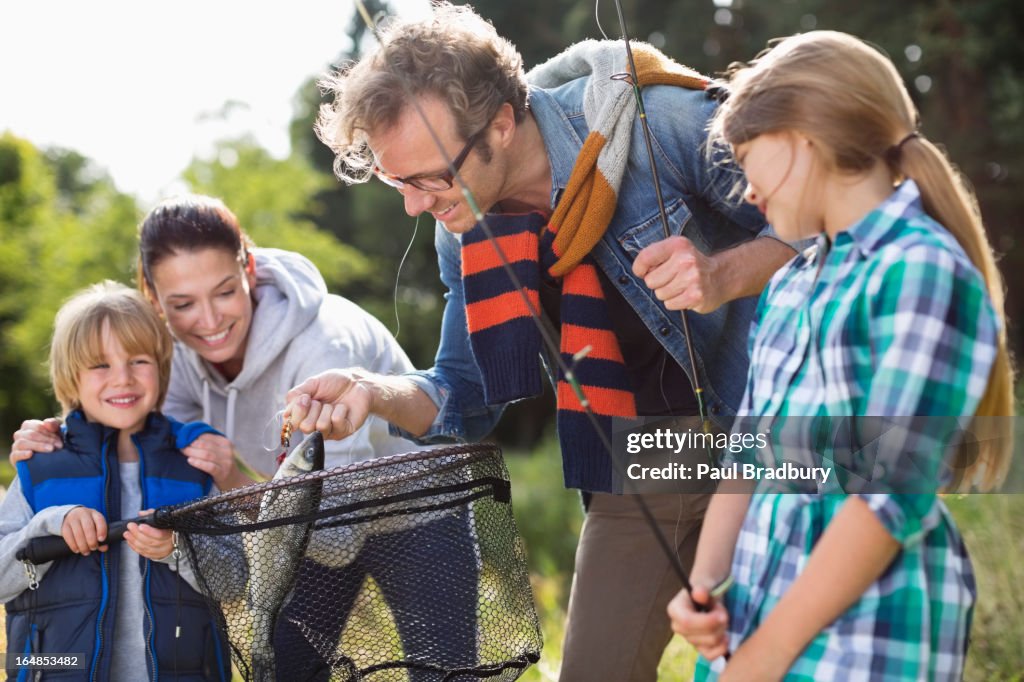 Family admiring fishing catch