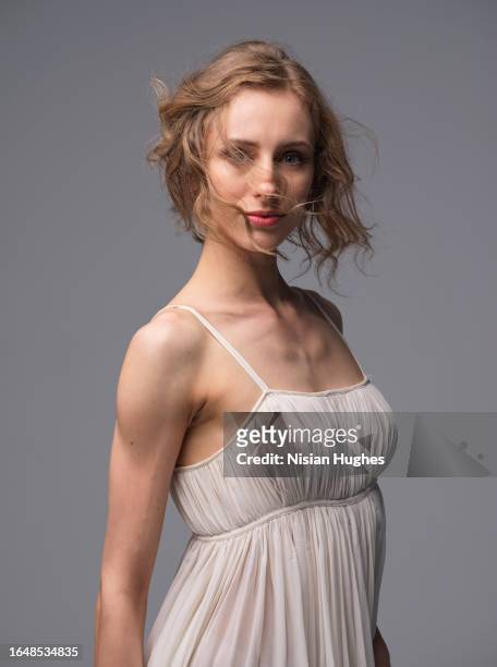 portrait of ballet dancer in studio wearing beautiful white dress. - performing arts center stock pictures, royalty-free photos & images