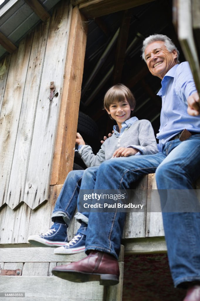 Man and grandson sitting in doorway