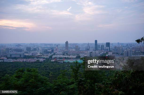 skyline of jinan at dusk - jinan city stock pictures, royalty-free photos & images