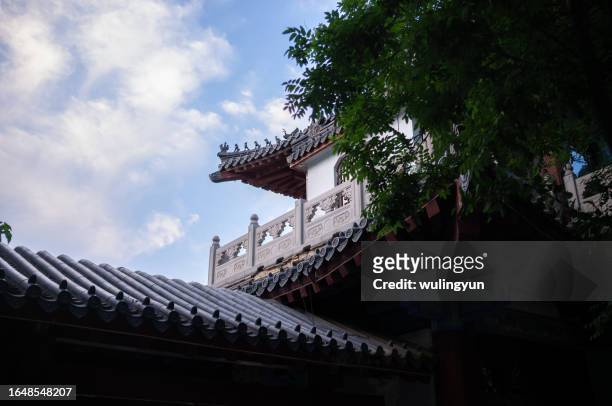 chinese flying eaves against blue sky - jinan city stock pictures, royalty-free photos & images