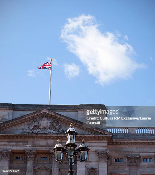 british flag over ornate building - buckingham palace stock-fotos und bilder
