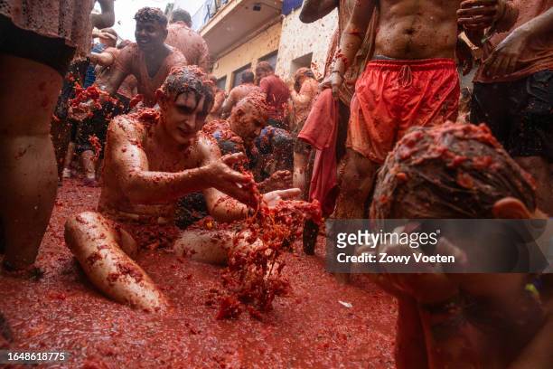 Participants have fun throwing tomatoes mixed with water on August 30, 2023 in Bunol, Spain. Spain's tomato throwing party in the streets of Bunol,...