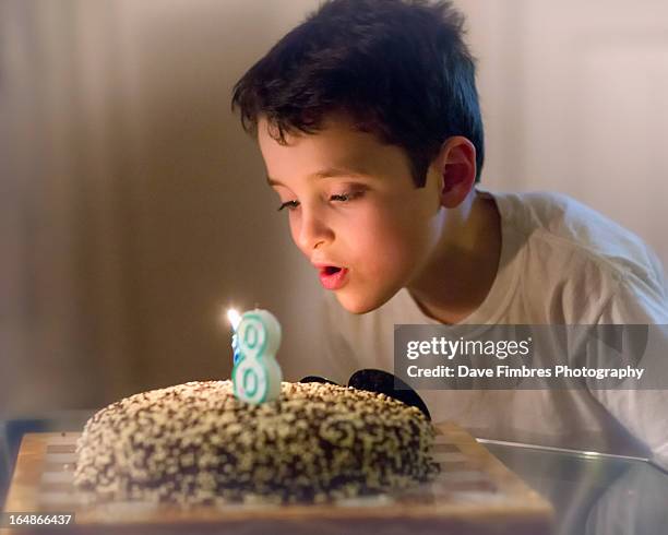 boy blowing out the candle - mclean stock pictures, royalty-free photos & images