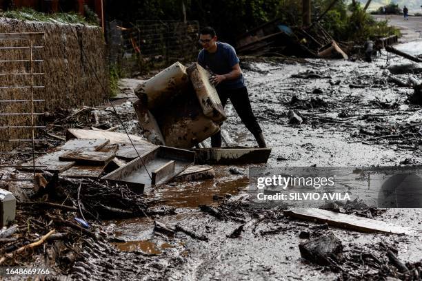 Man removes debris in the aftermath of a cyclone in Muçum, Rio Grande do Sul State, Brazil, on September 6, 2023. The death toll from a cyclone that...