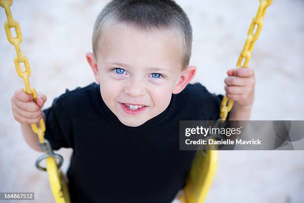 Little Boy At The Park On A Swing High-Res Stock Photo - Getty Images