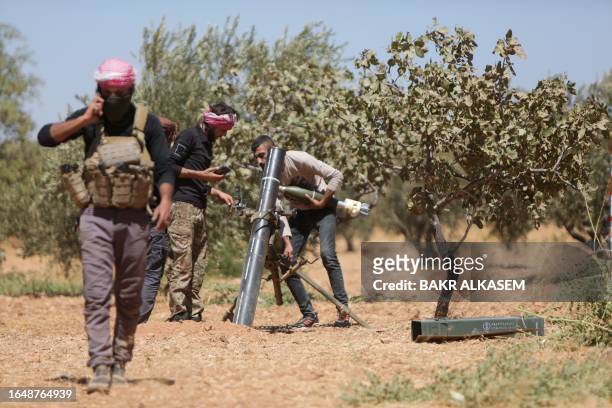 Fighters of Turkish-supported forces are positioned on the Buwayhij-Boughaz-Korhoyuk frontline on the outskirts of Manbij in northeastern Syria, as...