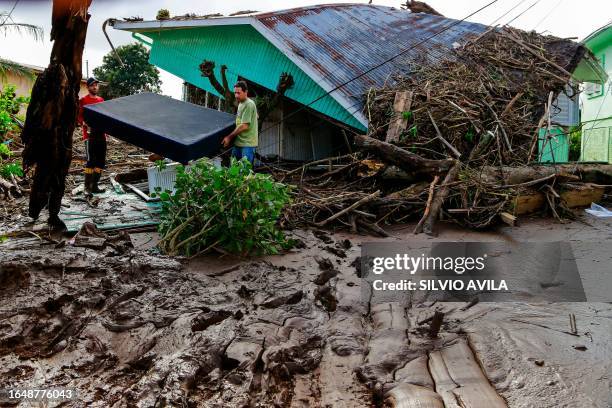 Residents salvage belongings amid mud and debris after a cyclone in Mucum, Rio Grande do Sul State, Brazil, on September 6, 2023. The death toll from...