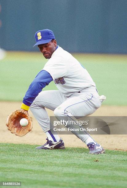 Harold Reynolds of the Seattle Mariners fields ground ball during batting practice before a Major League Baseball game against the Oakland Athletics...