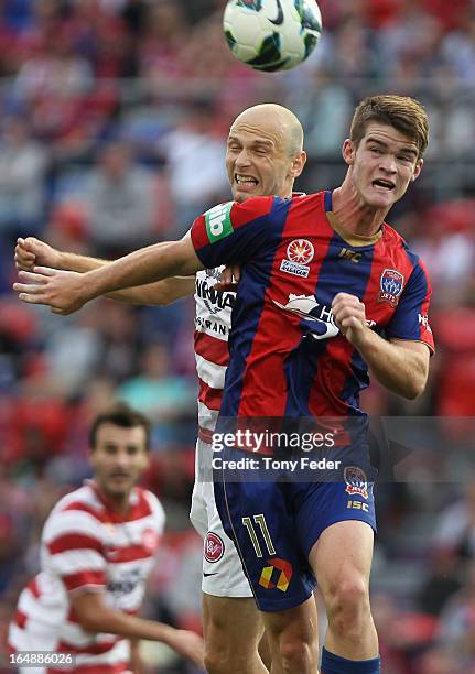 Connor Chapman of the Jets is tackled by Dino Kresinger of the Wanderers during the round 27 A-League match between the Newcastle Jets and Western...