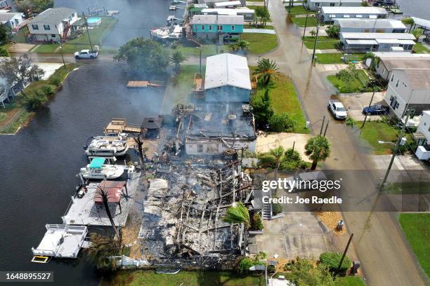In an aerial view, a home smolders after burning as Hurricane Idalia passed offshore on August 30, 2023 in Hudson, Florida. Hurricane Idalia hit the...