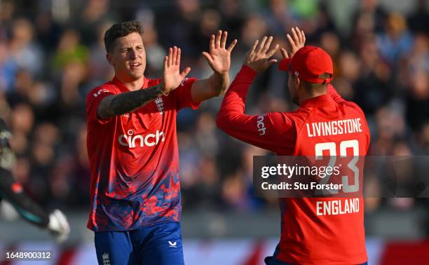 England bowler Brydon Carse celebrates with Liam Livingstone after bowling Finn Allen during the 1st Vitality T20 I match between England and New...