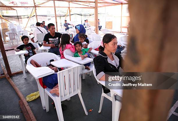 People, displaced by continuing armed conflict between the supporters of Philippine Muslim clan Sulu Sultan Jamalul Kiram III and Royal Malaysian...