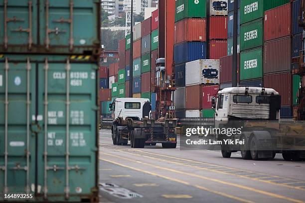 Container trucks and shipping containers stand unattended during industrial action at the Kwai Chung Container Terminal on March 29, 2013 in Hong...