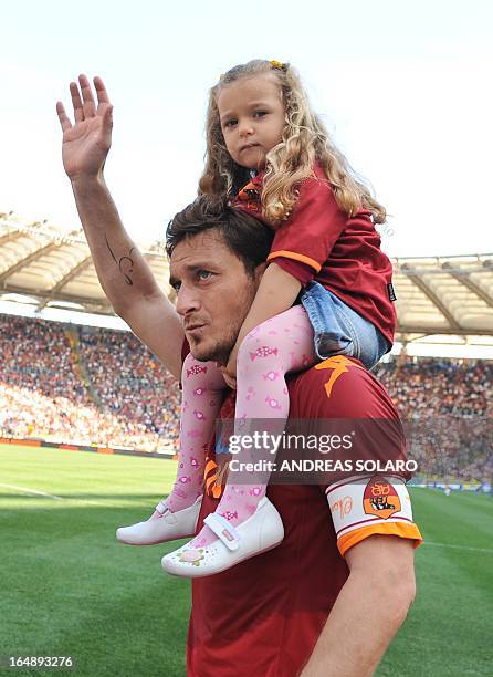 Roma's Captain Francesco Totti celebrates with daughter Chanel after his team's Italian Serie A football match against Cagliari on May 9, 2010 at...
