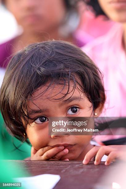 Young child, displaced by continuing armed conflict between the supporters of Philippine Muslim clan Sulu Sultan Jamalul Kiram III and Royal...