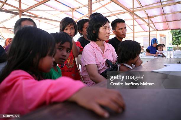 People, displaced by continuing armed conflict between the supporters of Philippine Muslim clan Sulu Sultan Jamalul Kiram III and Royal Malaysian...