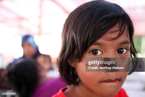 Young child, displaced by continuing armed conflict between the supporters of Philippine Muslim clan Sulu Sultan Jamalul Kiram III and Royal...