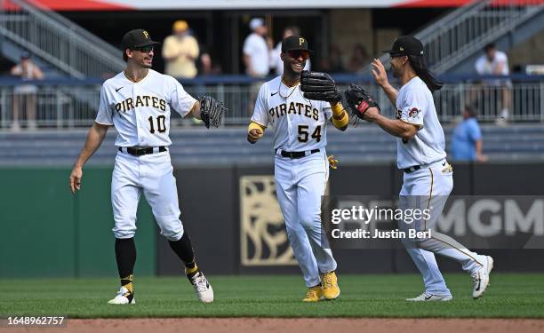 Joshua Palacios of the Pittsburgh Pirates celebrates with Connor Joe and Bryan Reynolds after the final out in a 5-4 win over the Milwaukee Brewers...