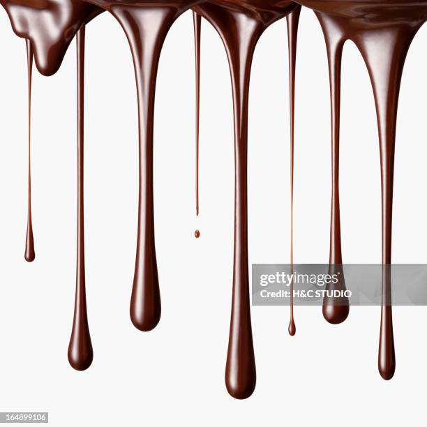 chocolate falling in drops - liquid chocolate stock pictures, royalty-free photos & images