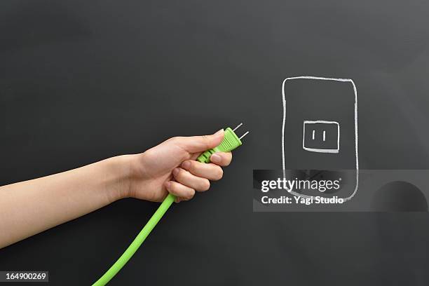 hand holding the plug, blackboard - plug in stock pictures, royalty-free photos & images