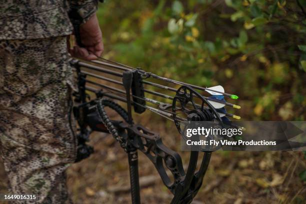 cropped photo of a hunter carrying a crossbow - arrows landscapes stock pictures, royalty-free photos & images