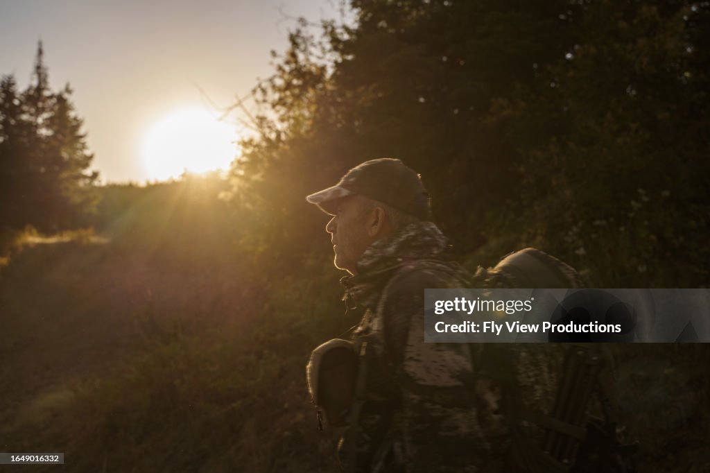 Man hunting elk in the Pacific Northwest at sunrise