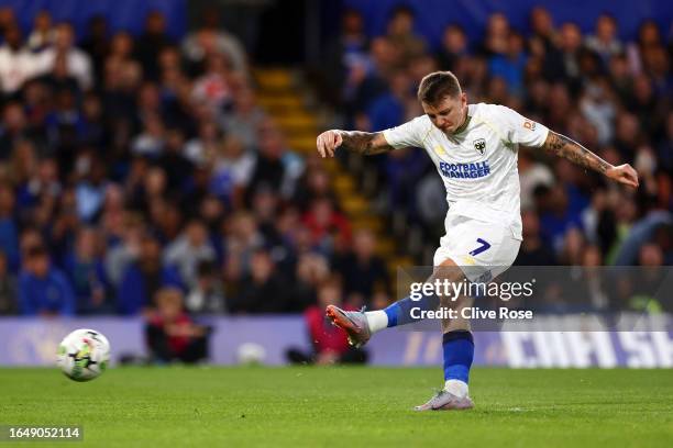 James Tilley of AFC Wimbledon scores the team's first goal from a penalty during the Carabao Cup Second Round match between Chelsea and AFC Wimbledon...