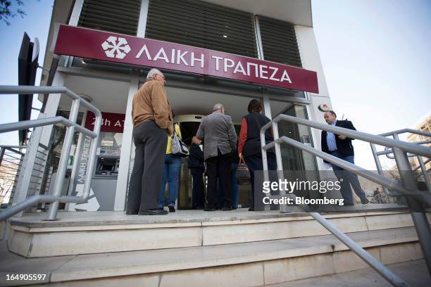 Customers queue outside a branch of a Cyprus Popular Bank Pcl, also known as Laiki Bank, in Nicosia, Cyprus, on Friday, March 29, 2013. Cypriots face...