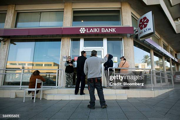 Customers queue outside a branch of a Cyprus Popular Bank Pcl, also known as Laiki Bank, in Nicosia, Cyprus, on Friday, March 29, 2013. Cypriots face...