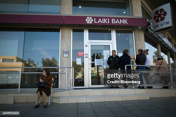 Customers queue outside a branch of a Cyprus Popular Bank Pcl, also known as Laiki Bank, in Nicosia, Cyprus, on Friday, March 29, 2013. Cypriots face...