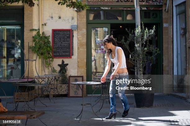 An employee prepares the outside terrace area of a cafe ahead of opening in Nicosia, Cyprus, on Friday, March 29, 2013. Cypriots face a second day of...