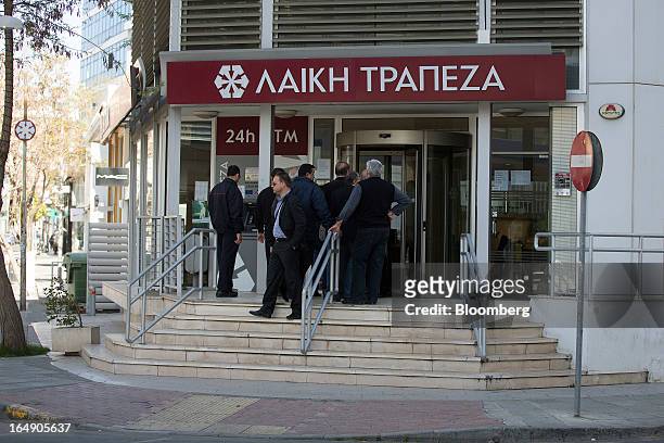 Customers queue outside a branch of Cyprus Popular Bank Pcl, also known as Laiki Bank, in Nicosia, Cyprus, on Friday, March 29, 2013. Cypriots face a...