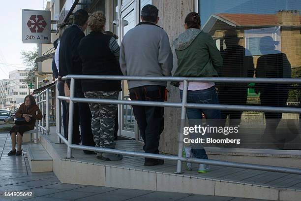 Customers queue outside a branch of Cyprus Popular Bank Pcl, also known as Laiki Bank, in Nicosia, Cyprus, on Friday, March 29, 2013. Cypriots face a...