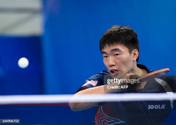 Adam Hugh of the US returns a shot during his match against Stefan Fegerl of Austria at the World Team Classic Table Tennis game in Guangzhou, east...