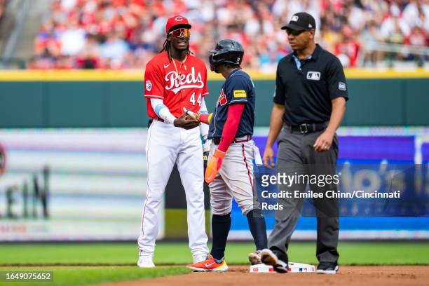 Elly De La Cruz of the Cincinnati Reds talks to Ronald Acuña Jr. #13 of the Atlanta Braves during a game at Great American Ball Park on June 24, 2023...