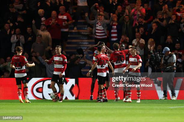 Joe Ironside of Doncaster Rovers celebrates with his teammates after scoring the team's first goal during the Carabao Cup Second Round match between...