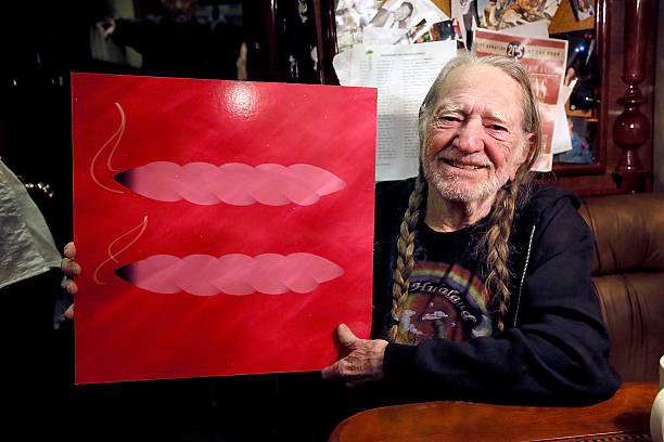Willie Nelson holds up the Human Rights Campaign marriage equality symbol that has been stylized into two "joints" during an interview on his bus the...
