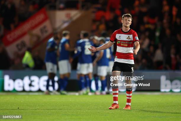 James Maxwell of Doncaster Rovers reacts as Arnaut Danjuma of Everton scores the team's second goal during the Carabao Cup Second Round match between...