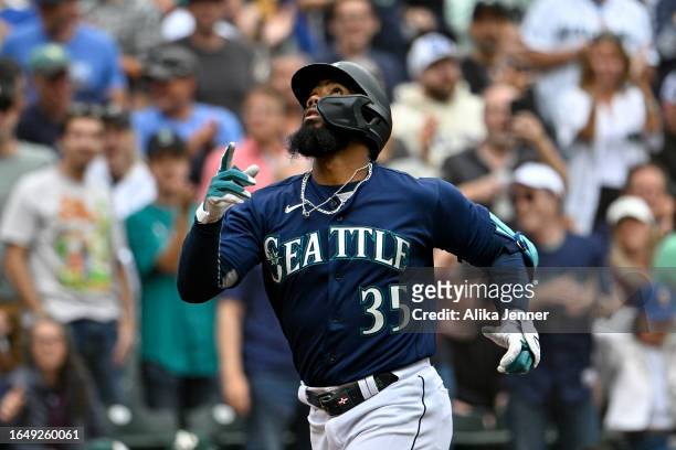 Teoscar Hernandez of the Seattle Mariners gestures while running the bases after hitting a three-run home run during the third inning against the...