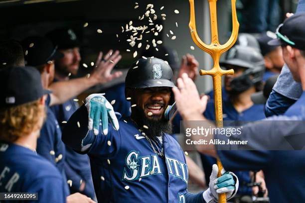 Teoscar Hernandez of the Seattle Mariners celebrates with teammates after hitting a three-run home run during the third inning against the Oakland...