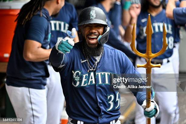 Teoscar Hernandez of the Seattle Mariners celebrates with teammates after hitting a three-run home run during the third inning against the Oakland...