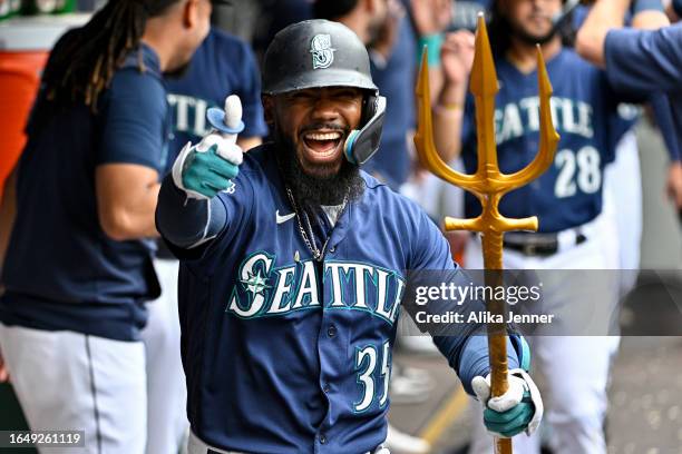 Teoscar Hernandez of the Seattle Mariners celebrates with teammates after hitting a three-run home run during the third inning against the Oakland...