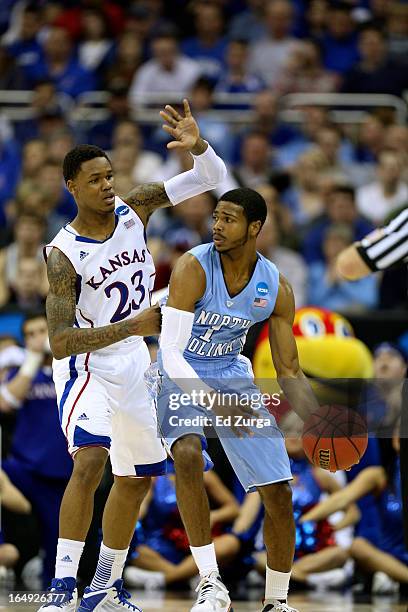 Ben McLemore of the Kansas Jayhawks defends Dexter Strickland of the North Carolina Tar Heels during the third round of the 2013 NCAA Men's...