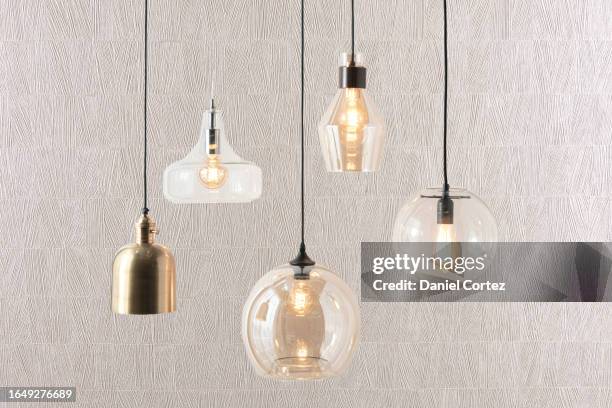 a set of overhead modern bulb lamps fixture mounted on a wall in a bright room room - lamp foto e immagini stock