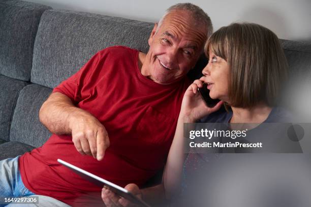 couple using digital tablet - older couple using tablet stock pictures, royalty-free photos & images