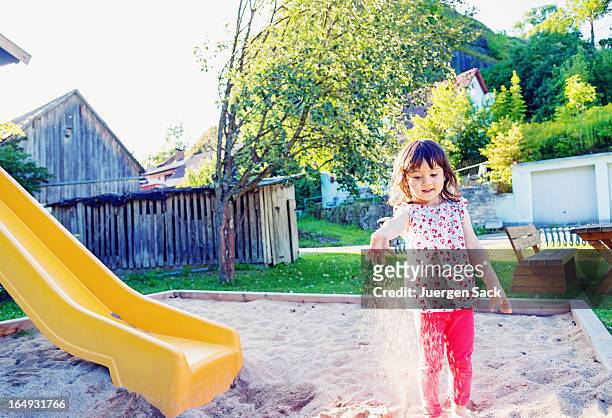 playing with sand - 2 girls 1 sandbox stock pictures, royalty-free photos & images