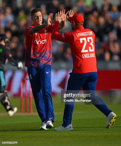 England bowler Brydon Carse celebrates with Liam Livingstone after bowling Finn Allen during the 1st Vitality T20 I match between England and New...